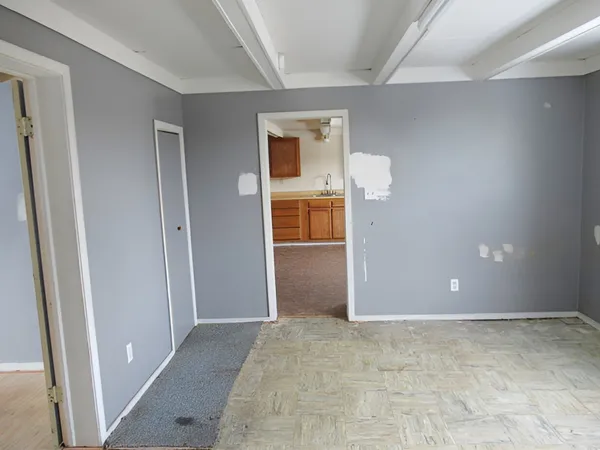 a view of a big room with closet and wooden door