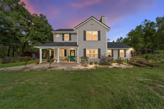 a front view of a house with a garden and patio