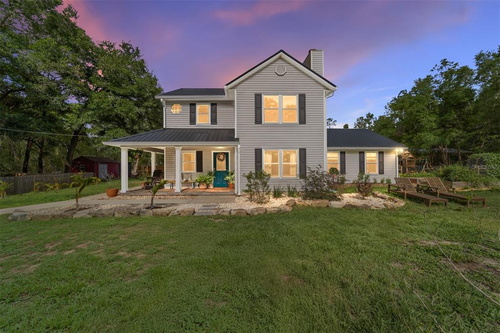 a front view of a house with a garden and patio