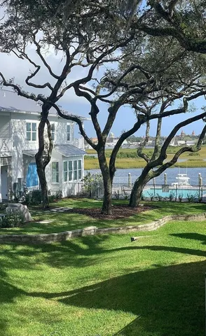 a house with a big yard and large trees