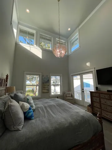 a spacious bedroom with a bed and a flat screen tv