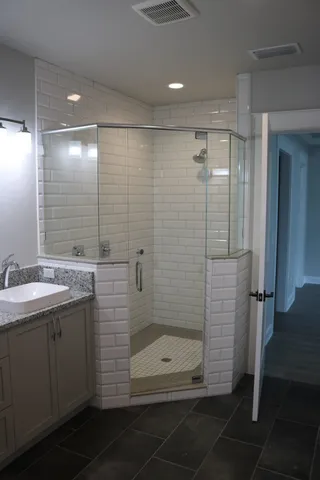 a bathroom with a shower and a sink