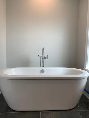 a white bath tub sitting in a bathroom
