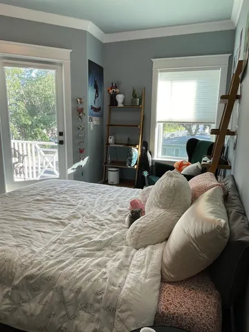 a bedroom with furniture and a window