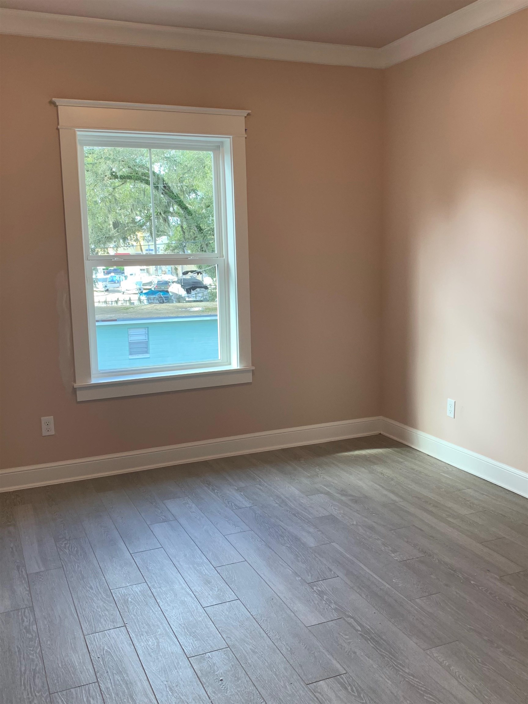 121 Cherokee Street St. Augustine, FL 32084 - Photo 24 of 33 a view of an empty room with wooden floor and a window