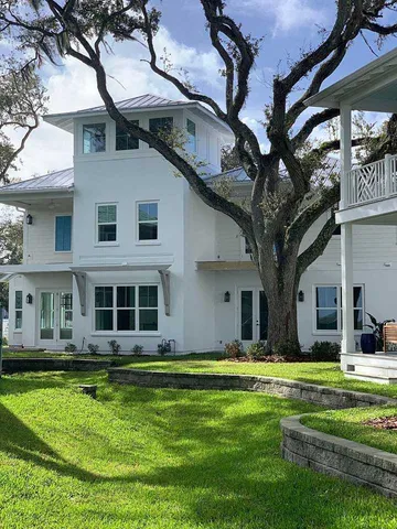 a front view of a house with a yard table and chairs