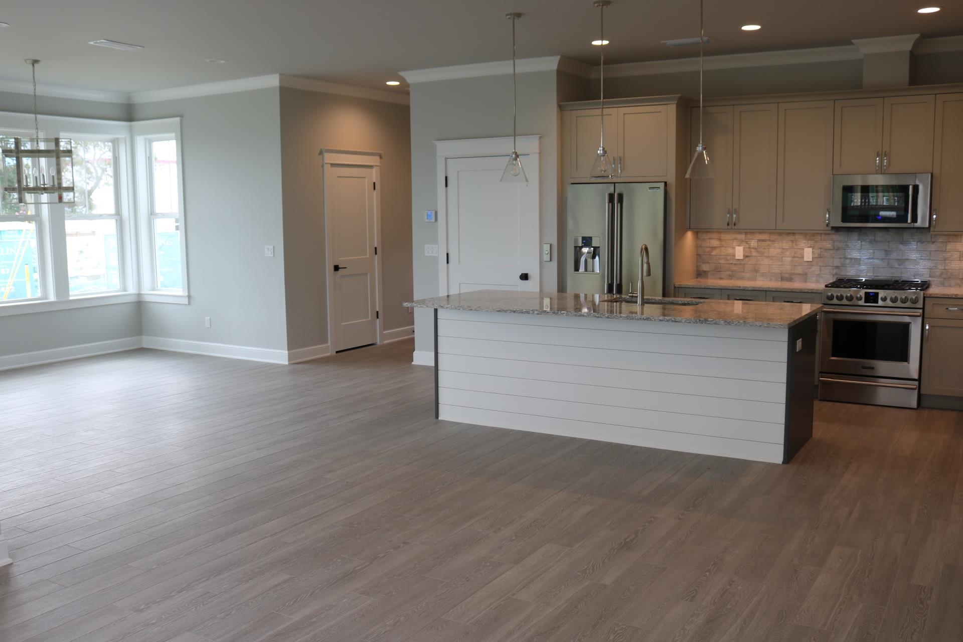 121 Cherokee Street St. Augustine, FL 32084 - Photo 9 of 33 a large kitchen with stainless steel appliances granite countertop a stove and a refrigerator