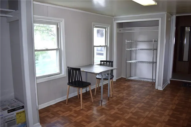 a view of walk in closet with wooden floor