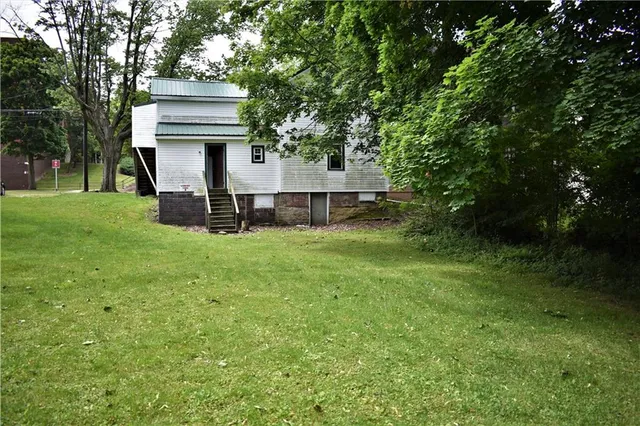 a view of a house with a yard porch and sitting area