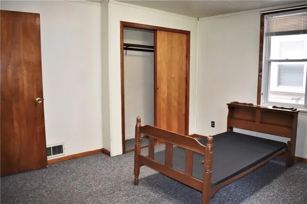 a room with a bed and a window