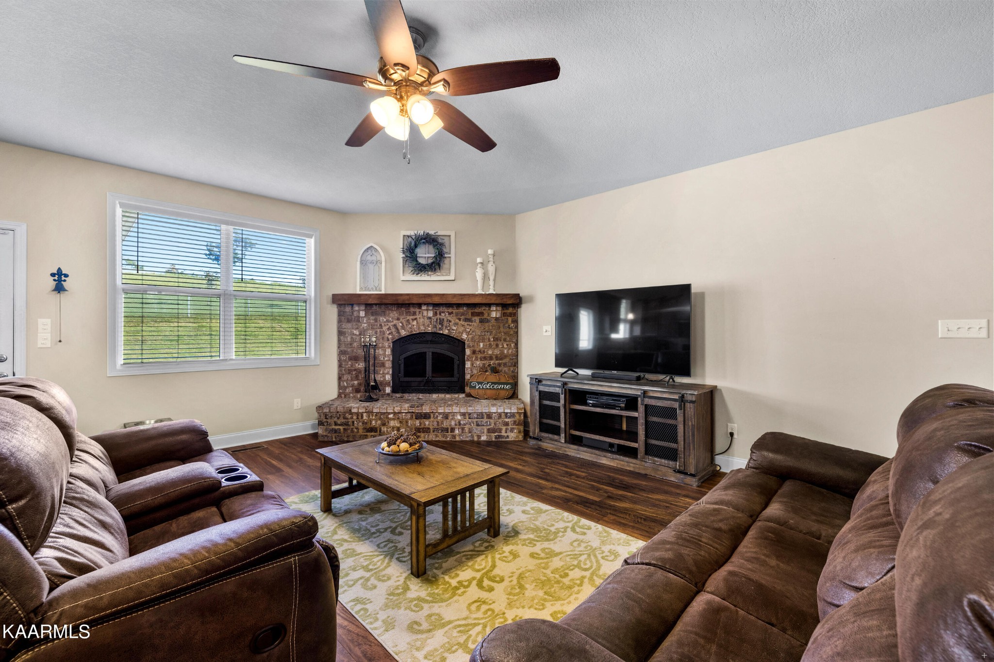 820 Kodak Road Kodak, TN 37764 - Photo 4 of 45 a living room with furniture a flat screen tv and a fireplace