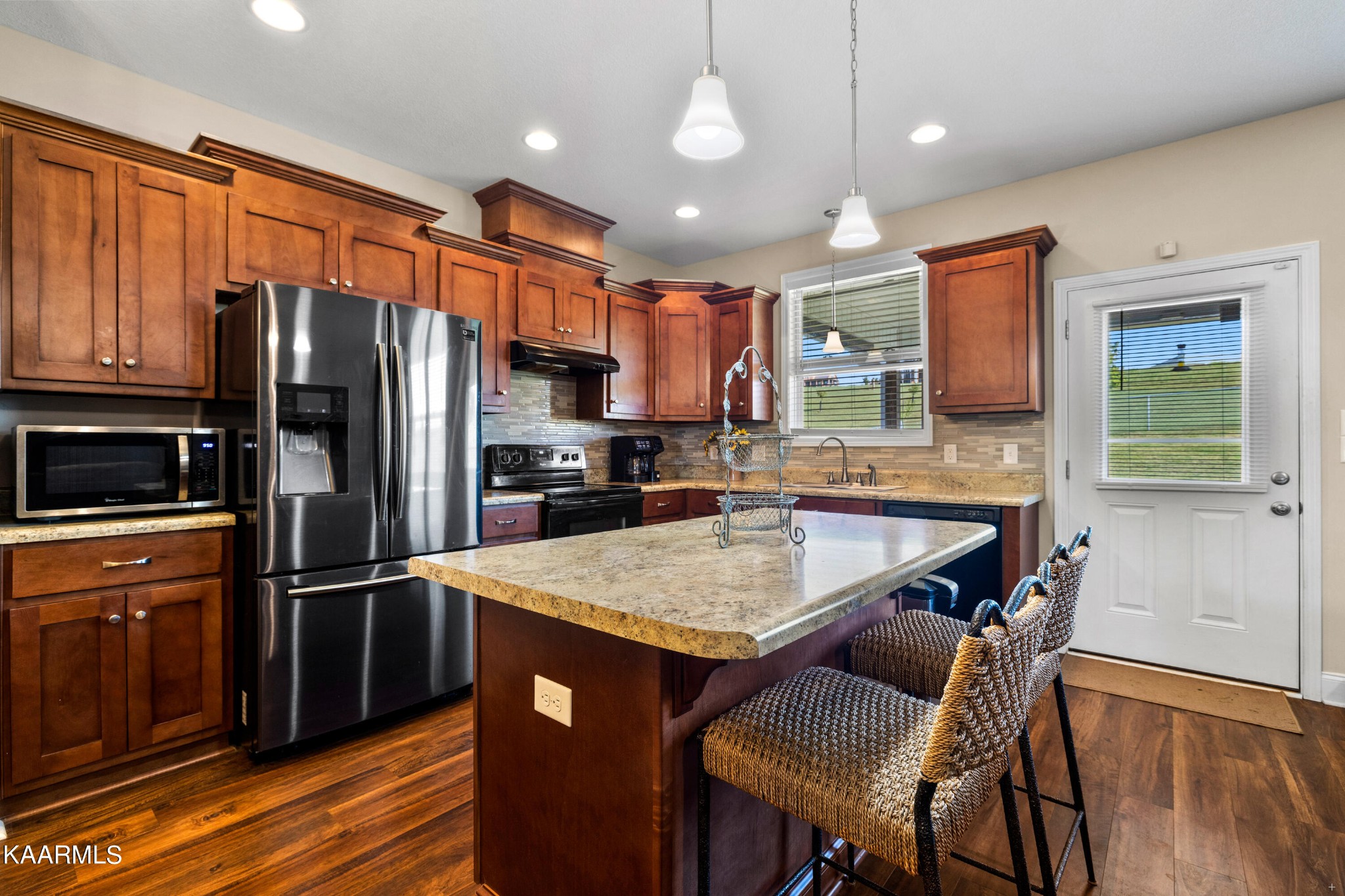 820 Kodak Road Kodak, TN 37764 - Photo 10 of 45 a kitchen with stainless steel appliances granite countertop a refrigerator a stove a sink a dining table and chairs