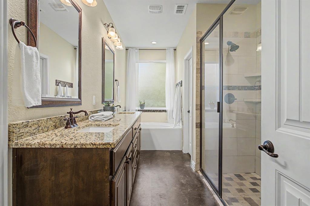 203 Saddle Ridge Court Springtown, TX 76082 - Photo 23 of 39 Dual sinks and a big vanity - custom framed mirrors - soaking tub - BIG walk-in shower. Sign me up!