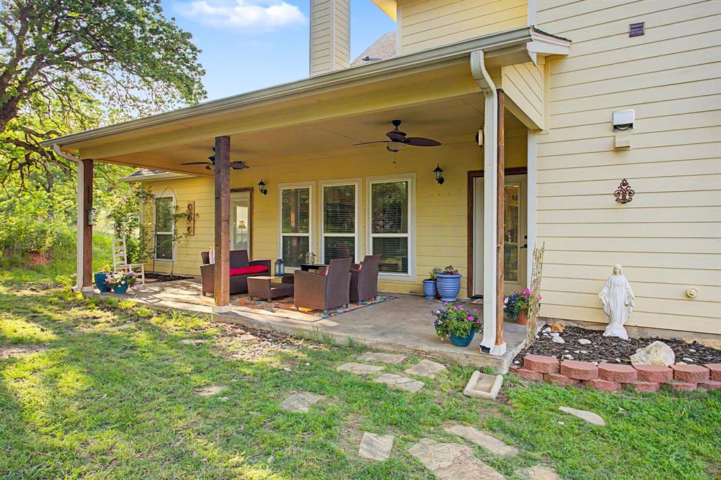 203 Saddle Ridge Court Springtown, TX 76082 - Photo 35 of 39 Big back porch for another great hangout spot outside.