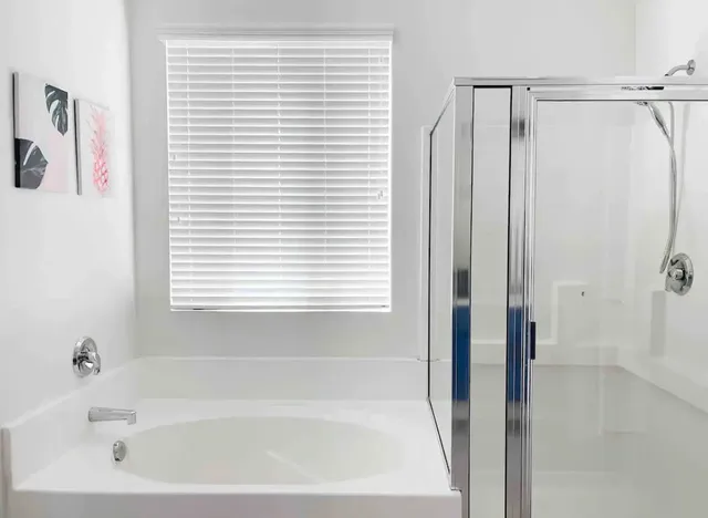 a bathroom with a bathtub and a shower