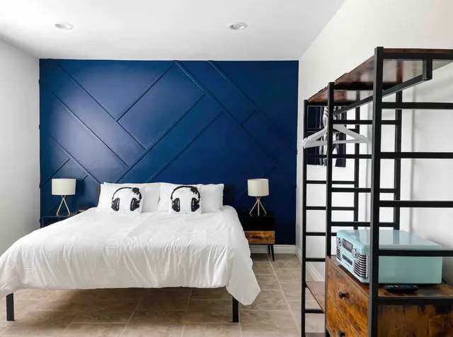 a bed sitting in a bedroom next to a window