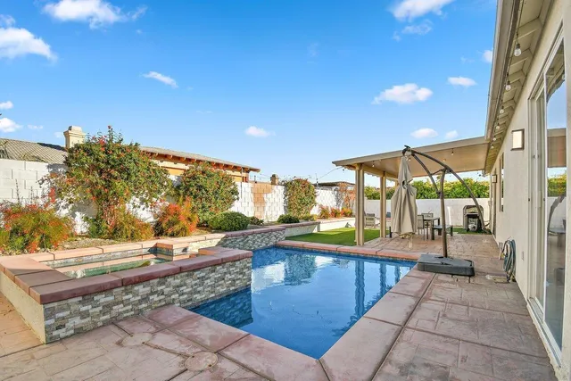 a view of a swimming pool with a patio