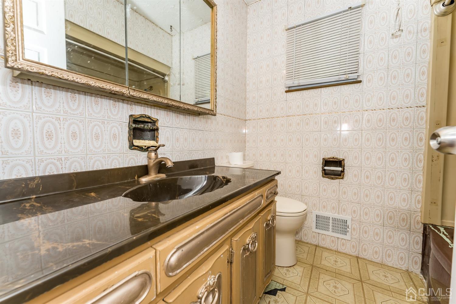186 McFarlane Road Colonia, NJ 07067 - Photo 14 of 22 a bathroom with a granite countertop sink a toilet and mirror