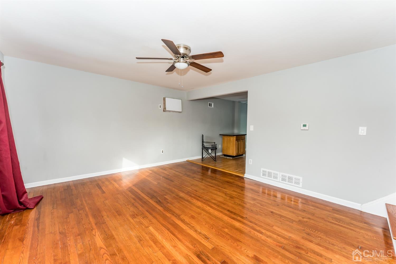 186 McFarlane Road Colonia, NJ 07067 - Photo 3 of 22 a view of empty room with wooden floor