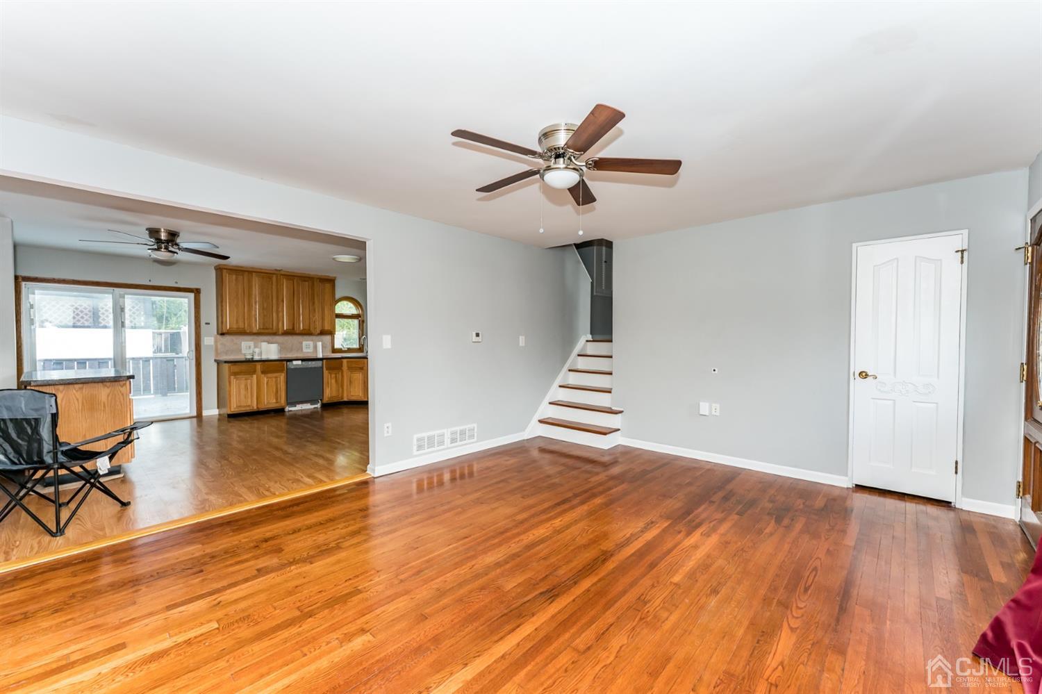 186 McFarlane Road Colonia, NJ 07067 - Photo 4 of 22 a view of an empty room with a window and wooden floor