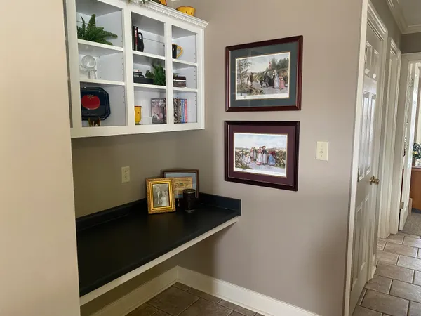 a bathroom with a sink a toilet a mirror a vanity and window
