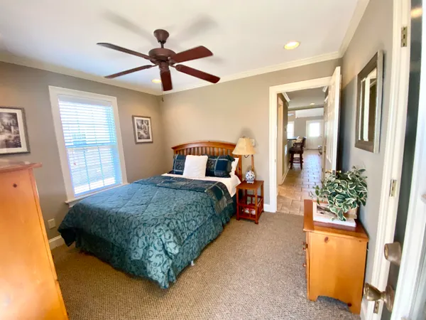 a bedroom with a bed dresser and a window
