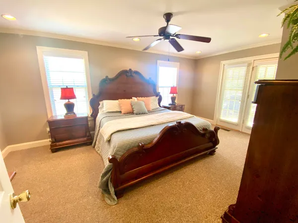 a bedroom with a bed and a chandelier