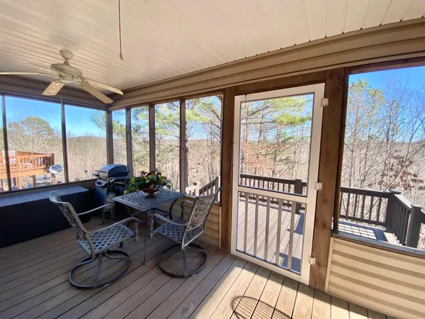 a view of balcony with wooden floor and fence