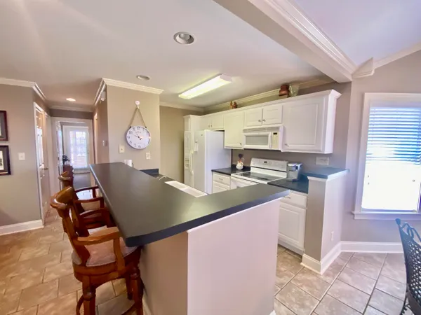 a large kitchen with stainless steel appliances a stove and a refrigerator