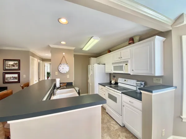a view of a hallway with front door and wooden floor