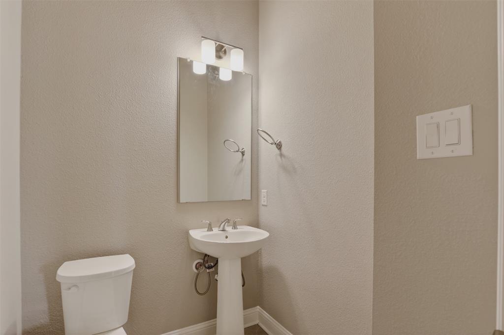 16812 Bitterroot Road Justin, TX 76247 - Photo 12 of 27 a bathroom with a sink toilet and a mirror
