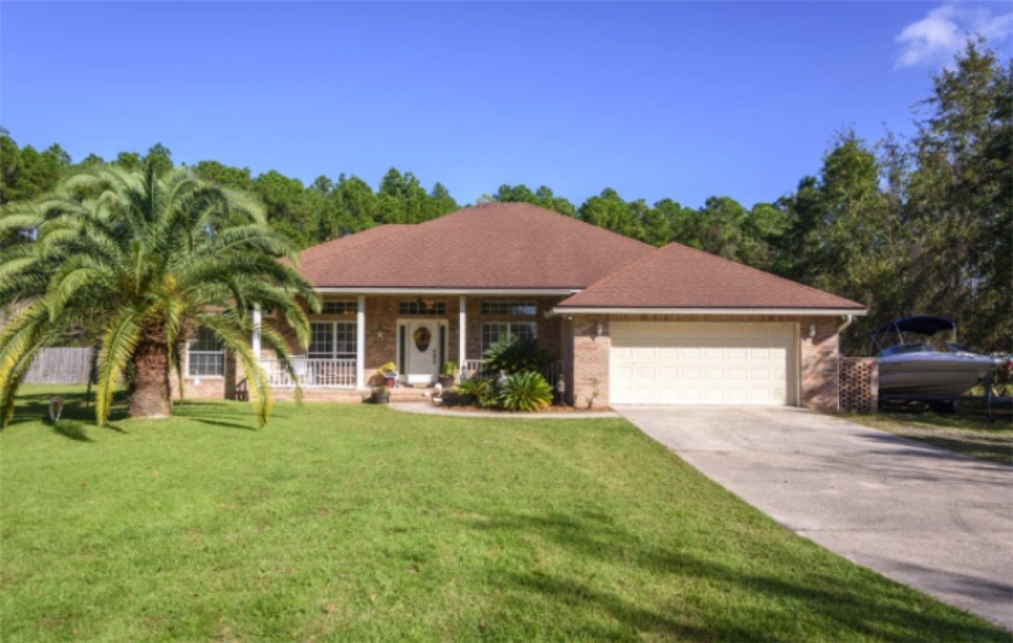 75020 Edwards Road Yulee, FL 32097 - Photo 1 of 6 a view of a house with a yard and sitting area