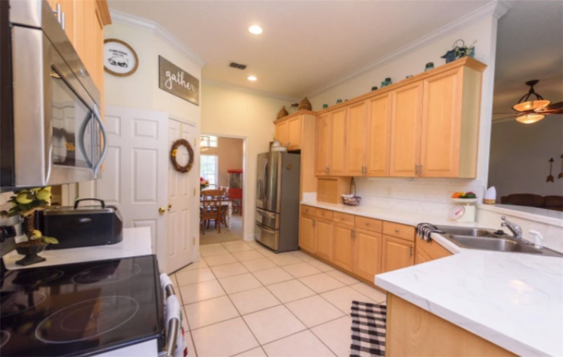 75020 Edwards Road Yulee, FL 32097 - Photo 3 of 6 a kitchen with a sink a stove and a refrigerator
