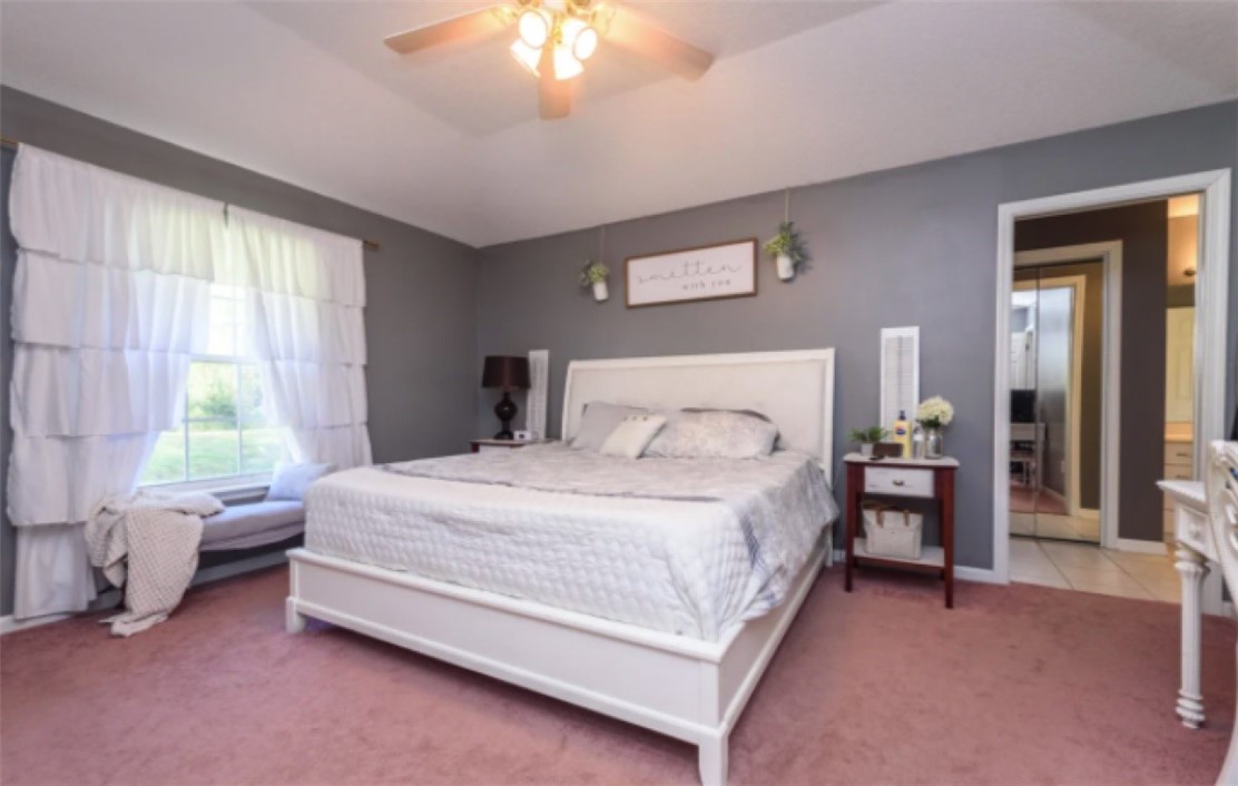 75020 Edwards Road Yulee, FL 32097 - Photo 5 of 6 a bedroom with a bed and a chandelier
