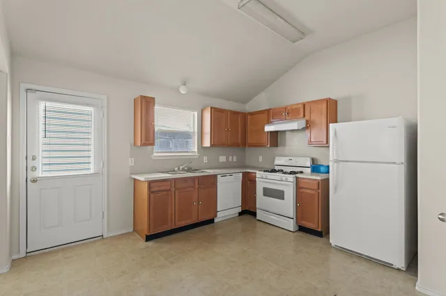 a kitchen with a sink stove and refrigerator