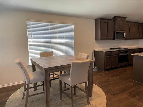 a kitchen with stainless steel appliances wooden floors and wooden cabinets