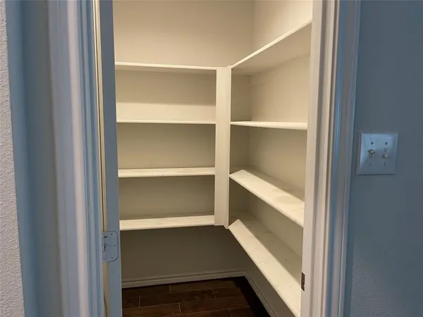 a view of walk in closet with empty racks