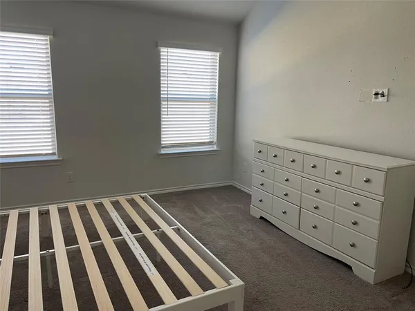 a view of an empty room with windows