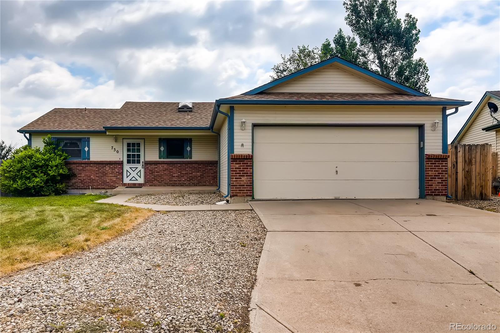 730 Douglas Place Berthoud, CO 80513 - Photo 1 of 28 a front view of a house with a yard and garage