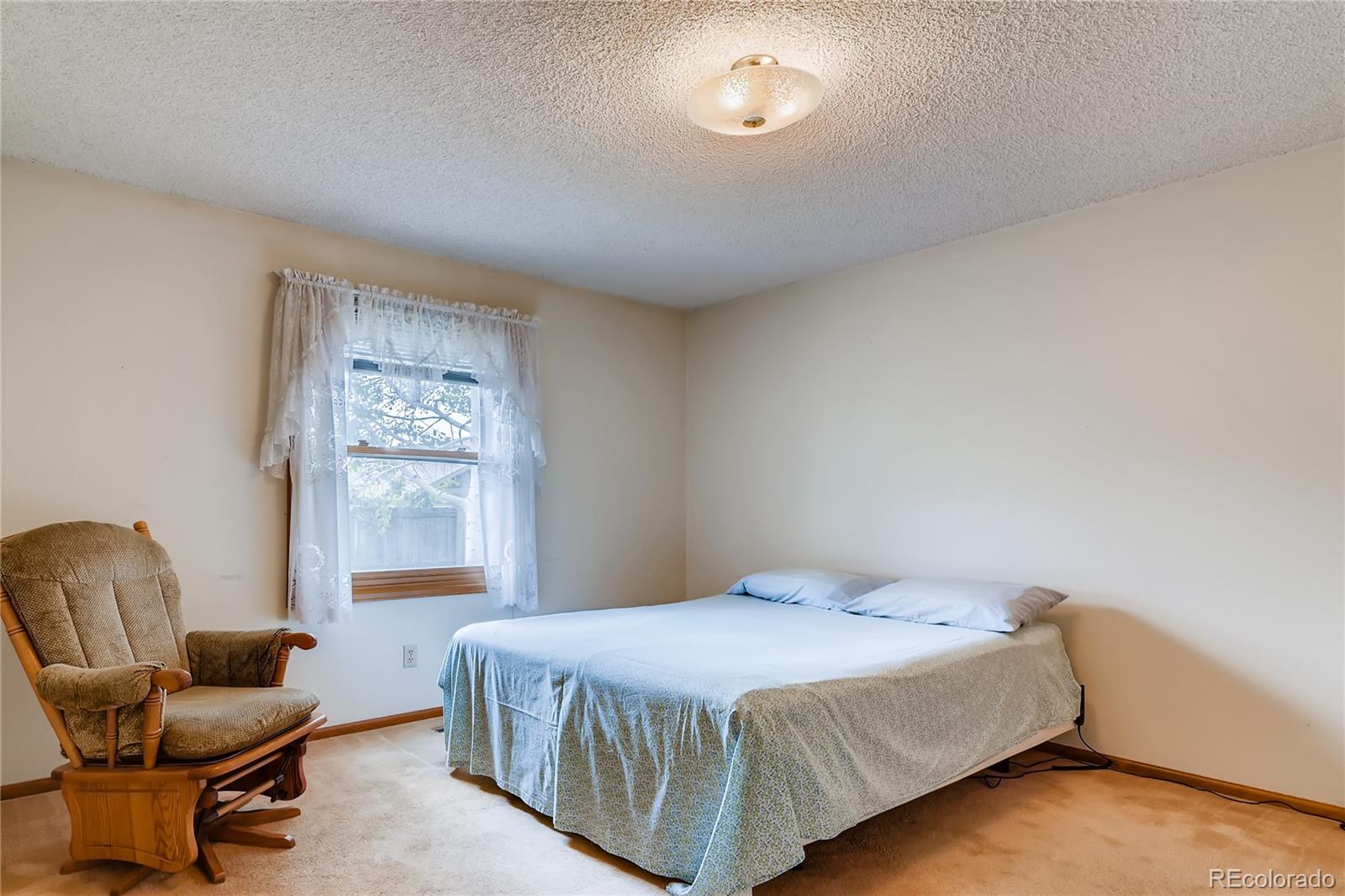 730 Douglas Place Berthoud, CO 80513 - Photo 13 of 28 a bedroom with a bed chair and couch