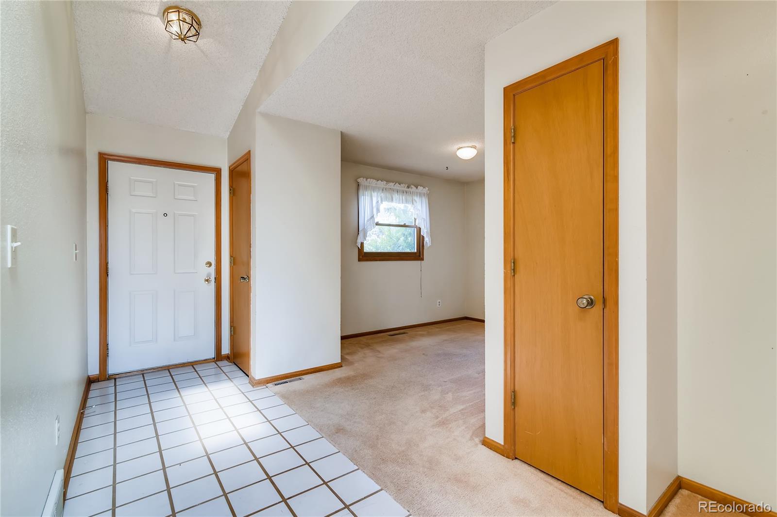 730 Douglas Place Berthoud, CO 80513 - Photo 4 of 28 a view of an empty room with windows & cabinet