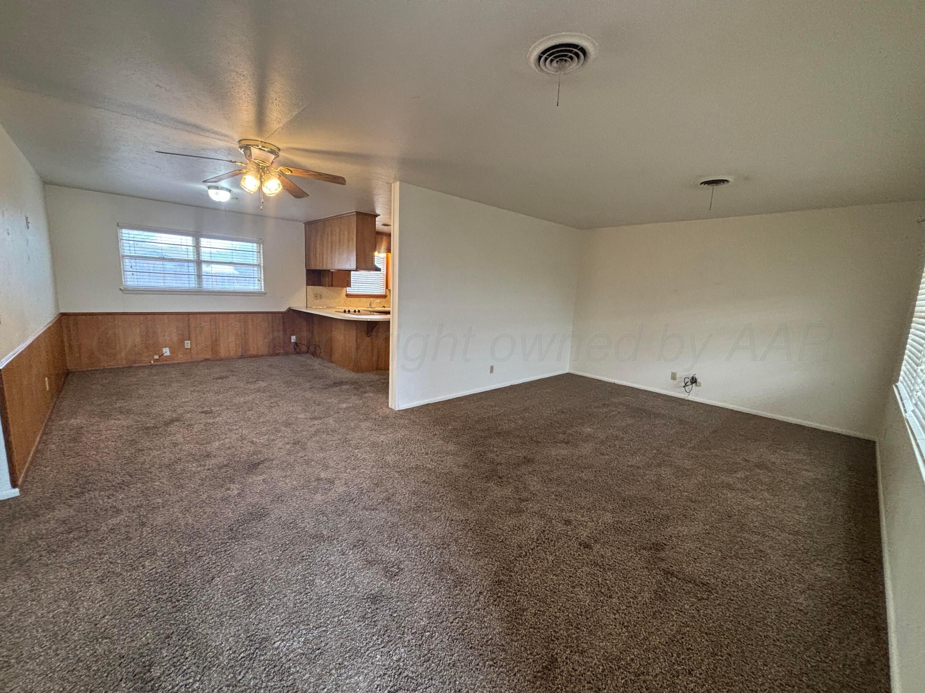 442 Harvey Street Miami, TX 79059 - Photo 15 of 19 a view of a room a ceiling fan and window