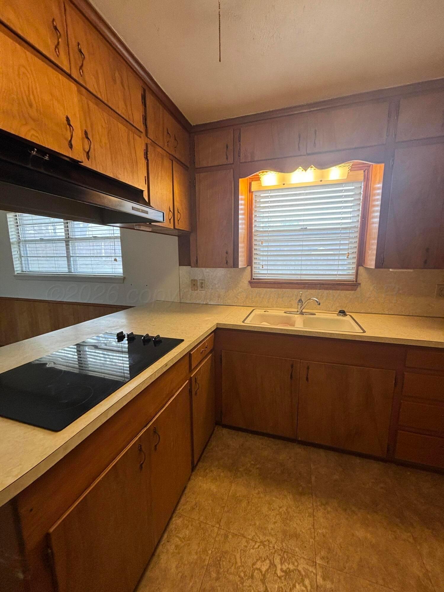 442 Harvey Street Miami, TX 79059 - Photo 4 of 19 a kitchen with stainless steel appliances granite countertop a sink and a stove