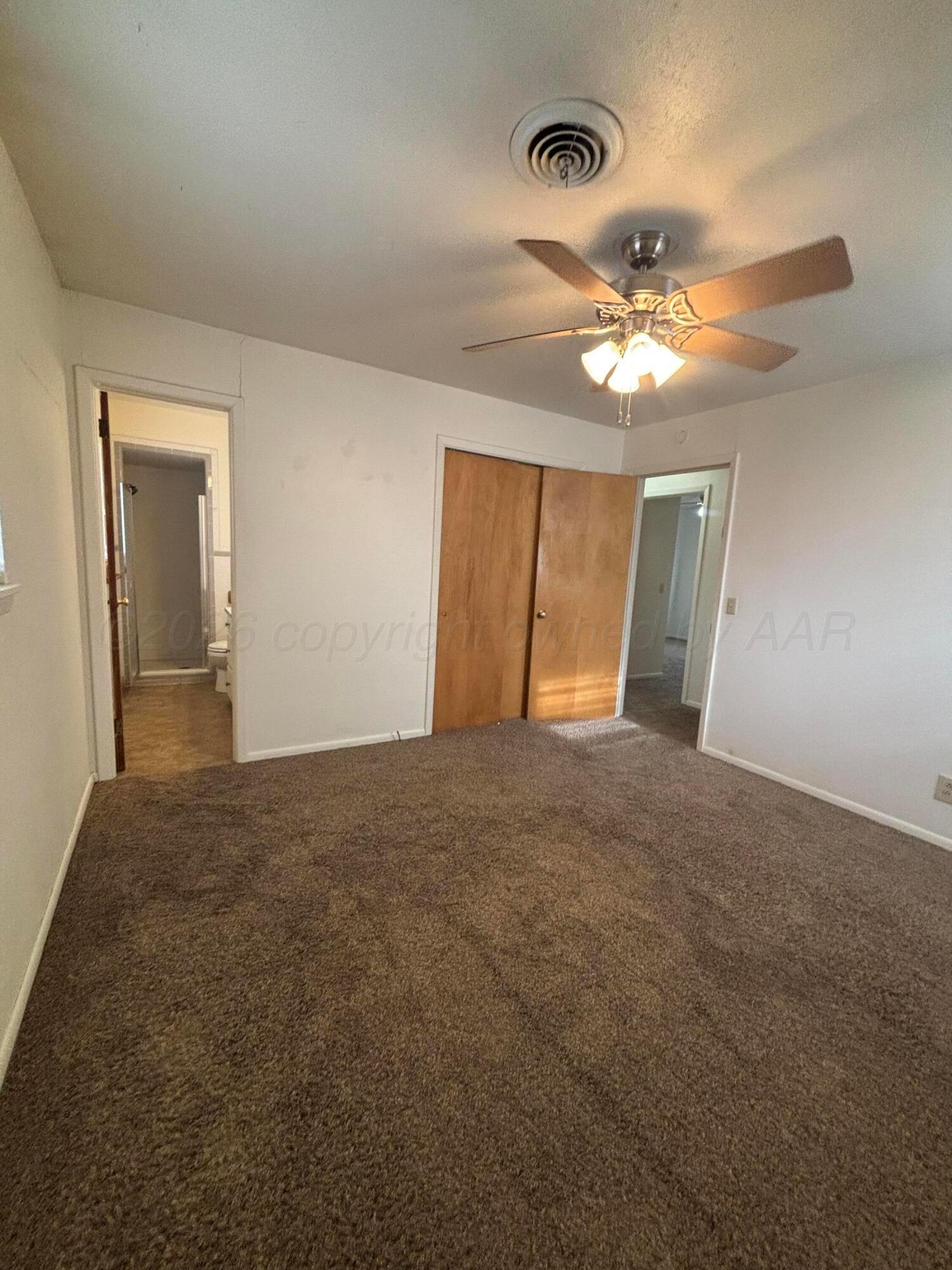 442 Harvey Street Miami, TX 79059 - Photo 5 of 19 a view of an empty room and chandelier fan