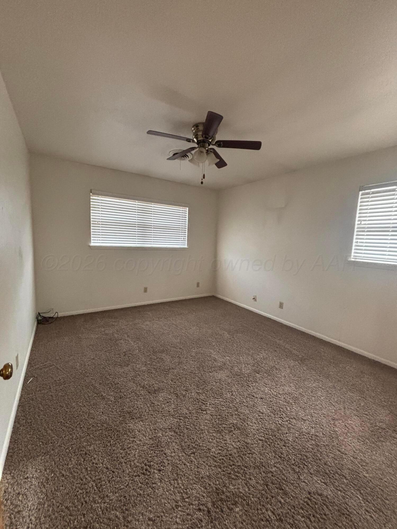 442 Harvey Street Miami, TX 79059 - Photo 10 of 19 an empty room with a ceiling fan and window