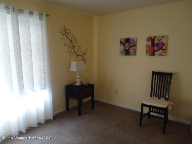 129 Ballantine Road Middletown, NJ 07748 - Photo 16 of 33 a living room with furniture and a window