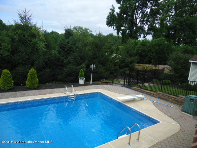 129 Ballantine Road Middletown, NJ 07748 - Photo 26 of 33 a view of pool with lawn chairs and plants