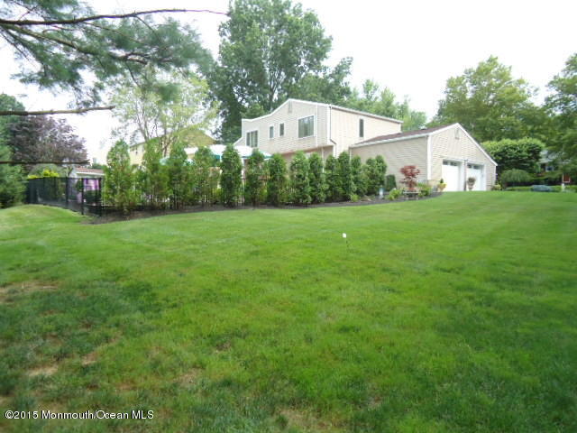 129 Ballantine Road Middletown, NJ 07748 - Photo 31 of 33 a front view of house with yard and green space