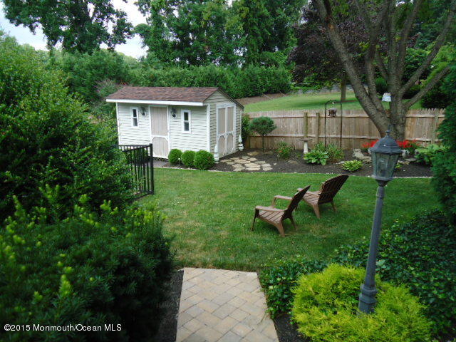 129 Ballantine Road Middletown, NJ 07748 - Photo 32 of 33 a view of a house with backyard sitting area and garden