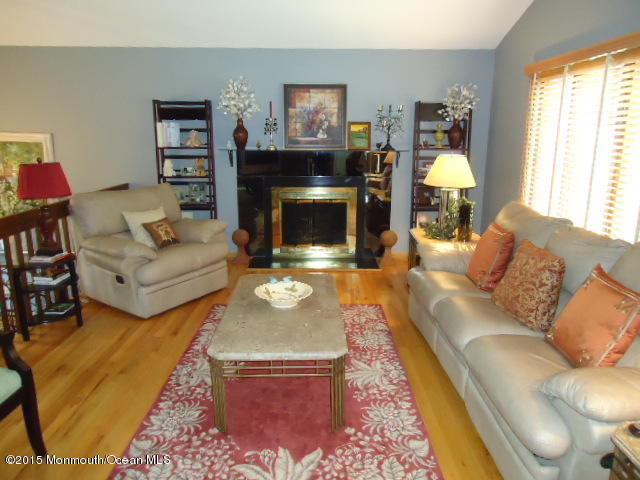 129 Ballantine Road Middletown, NJ 07748 - Photo 6 of 33 a living room with furniture and a fireplace